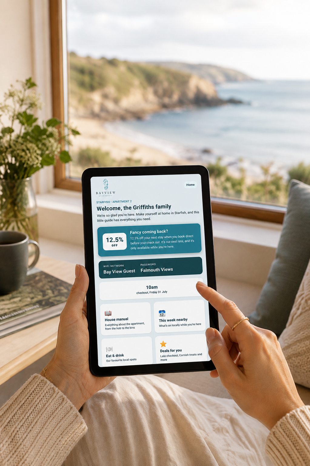 A guest using the concierge welcome screen, with a sea view behind